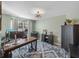 Home office with large desk, ample natural light, and stylish decor at 545 Pintail Cir, Auburndale, FL 33823