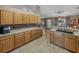 Bright kitchen boasts extensive cabinetry, tile floors, and an island at 545 Pintail Cir, Auburndale, FL 33823