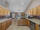Spacious kitchen featuring ample cabinetry, tile flooring and a large island at 545 Pintail Cir, Auburndale, FL 33823