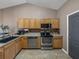 Well-equipped kitchen featuring stainless steel appliances and wood cabinets at 545 Pintail Cir, Auburndale, FL 33823