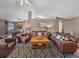 Bright living room featuring a comfortable leather sectional sofa and a wood coffee table at 545 Pintail Cir, Auburndale, FL 33823