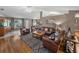 Spacious living room with leather furniture, a large area rug, and a view of the backyard at 545 Pintail Cir, Auburndale, FL 33823
