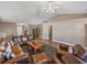 Open living room with leather furniture, wood flooring, and a ceiling fan at 545 Pintail Cir, Auburndale, FL 33823