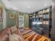Home office with built-in shelves, comfortable sofa, and TV at 545 Pintail Cir, Auburndale, FL 33823