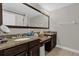 Double vanity bathroom with granite countertops and dark brown cabinets at 8121 Roseville Blvd, Davenport, FL 33896