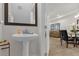 Small bathroom with pedestal sink and dark-framed mirror at 8121 Roseville Blvd, Davenport, FL 33896