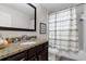 Bathroom with shower/tub combo and striped shower curtain at 8121 Roseville Blvd, Davenport, FL 33896