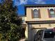 Townhome exterior showcasing tan walls, brown roof, and dark shutters at 8121 Roseville Blvd, Davenport, FL 33896