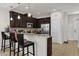 Kitchen with breakfast bar, dark cabinets, and stainless steel appliances at 8121 Roseville Blvd, Davenport, FL 33896