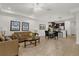 Open living room and dining area with tile floors and neutral decor at 8121 Roseville Blvd, Davenport, FL 33896
