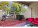 Private patio with red couch and grill, perfect for outdoor relaxation at 8121 Roseville Blvd, Davenport, FL 33896