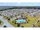 Aerial view of community with houses and central pool at 965 Shady Tree Ln, Davenport, FL 33897