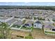 Aerial view of neighborhood with houses and solar panels at 965 Shady Tree Ln, Davenport, FL 33897