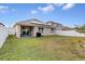 Large backyard with a home and fence at 965 Shady Tree Ln, Davenport, FL 33897