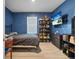 Blue bedroom with a double bed, large TV, and ample storage at 965 Shady Tree Ln, Davenport, FL 33897