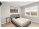 Bedroom with a double bed, a side table, and a large window at 965 Shady Tree Ln, Davenport, FL 33897