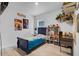 bedroom with a blue bed, desk, and shelves at 965 Shady Tree Ln, Davenport, FL 33897