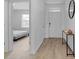Light and airy entryway with wood floors and a view into a bedroom at 965 Shady Tree Ln, Davenport, FL 33897
