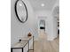 Bright entryway with light wood floors, a console table, and a large mirror at 965 Shady Tree Ln, Davenport, FL 33897