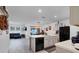 Open concept kitchen and living area with island, stainless steel appliances, and hardwood floors at 965 Shady Tree Ln, Davenport, FL 33897