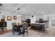 Open kitchen with gray cabinets, a large island with a bench, and a dining area at 965 Shady Tree Ln, Davenport, FL 33897