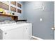Laundry room with washer, dryer, and shelving at 965 Shady Tree Ln, Davenport, FL 33897
