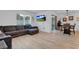 Open living and dining area with L-shaped sectional sofa and dining table at 965 Shady Tree Ln, Davenport, FL 33897