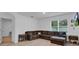 Living room with L-shaped sectional sofa and wood-look floors at 965 Shady Tree Ln, Davenport, FL 33897