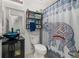 Small bathroom with blue sink, toilet and patterned shower curtain at 113 Promenade Ct, Auburndale, FL 33823
