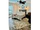 A cozy bedroom with a paisley comforter, ceiling fan, window, and a large area rug at 113 Promenade Ct, Auburndale, FL 33823