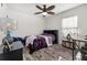 Cozy bedroom featuring a bed, nightstand, and ceiling fan at 113 Promenade Ct, Auburndale, FL 33823