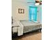 A bedroom featuring a comfortable bed, a large window, and soft, neutral tones at 113 Promenade Ct, Auburndale, FL 33823