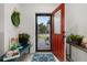 Inviting entryway with red door and decorative plants at 113 Promenade Ct, Auburndale, FL 33823