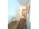 Hallway leading to a full bathroom with tile flooring and modern fixtures at 113 Promenade Ct, Auburndale, FL 33823