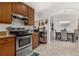 Kitchen with stainless steel appliances, granite counters, and view to dining area at 113 Promenade Ct, Auburndale, FL 33823