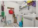 Well-equipped laundry room with washer, dryer, and storage at 113 Promenade Ct, Auburndale, FL 33823