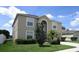 Two-story house with tan exterior, landscaping, and a two-car garage at 137 Milestone Dr, Haines City, FL 33844