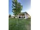 Covered patio, grassy yard, and outdoor seating area at 14827 Milfoil Ave, Orlando, FL 32827