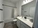 Clean bathroom with a bathtub, shower, and modern vanity at 14827 Milfoil Ave, Orlando, FL 32827