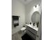 Stylish powder room with floating vanity and modern fixtures at 14827 Milfoil Ave, Orlando, FL 32827