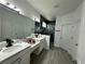 Spa-like bathroom featuring double sinks, a large shower, and grey tile floors at 14827 Milfoil Ave, Orlando, FL 32827