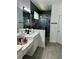 Elegant bathroom with double vanity, walk-in shower, and modern fixtures at 14827 Milfoil Ave, Orlando, FL 32827
