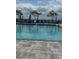 Community pool with lounge chairs and umbrellas at 14827 Milfoil Ave, Orlando, FL 32827