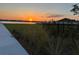 Lakefront community with sunset view and walking path at 14827 Milfoil Ave, Orlando, FL 32827