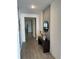 Bright entryway with wood-look tile floors and a console table at 14827 Milfoil Ave, Orlando, FL 32827
