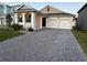 Two-car garage and front yard with paver driveway at 14827 Milfoil Ave, Orlando, FL 32827
