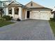 Two-car garage and front yard with paver driveway at 14827 Milfoil Ave, Orlando, FL 32827