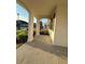Covered front porch with arched entryway and columns at 14827 Milfoil Ave, Orlando, FL 32827