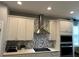 Kitchen features stainless steel range hood and white cabinets at 14827 Milfoil Ave, Orlando, FL 32827