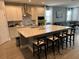 Spacious kitchen with white cabinets, large island, and stainless steel appliances at 14827 Milfoil Ave, Orlando, FL 32827